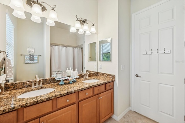 13215 Ramblewood Trl, Bradenton, FL 34211 - full bath with a sink, tile patterned floors, double vanity, and an inviting chandelier