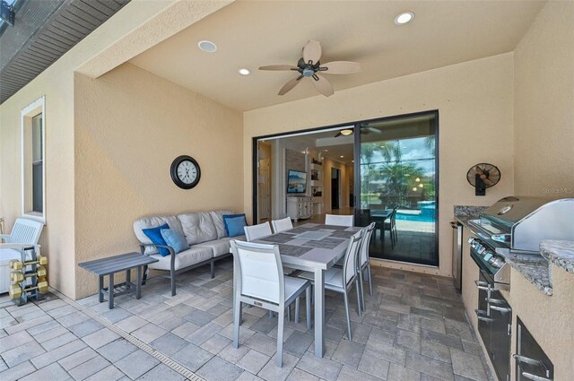 view of patio with an outdoor living space, ceiling fan, and area for grilling