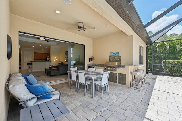 13215 Ramblewood Trl, Bradenton, FL 34211 - view of patio with an outdoor kitchen, ceiling fan, a grill, glass enclosure, and outdoor dining area