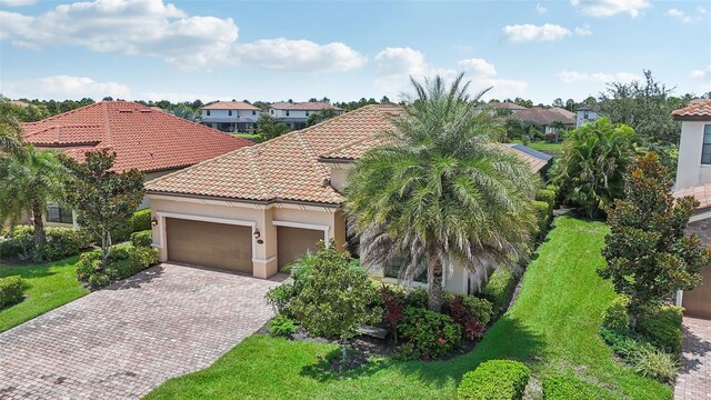 mediterranean / spanish home with a garage and a front yard