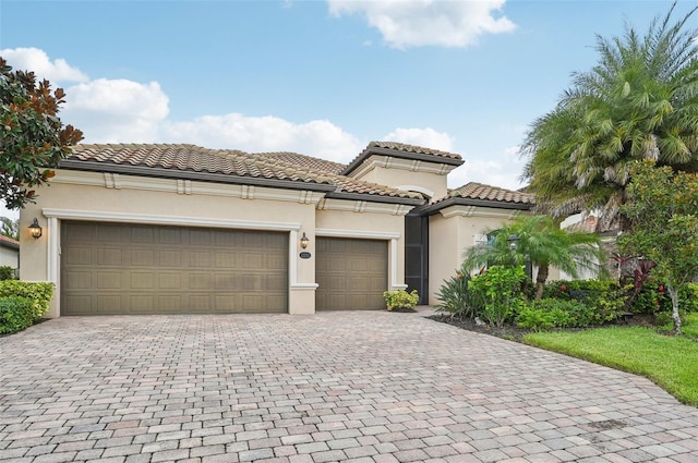 13215 Ramblewood Trl, Bradenton, FL 34211 - mediterranean / spanish-style house with a tiled roof, a garage, stucco siding, and decorative driveway