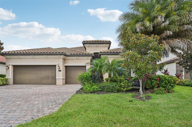 13215 Ramblewood Trl, Bradenton, FL 34211 - mediterranean / spanish home featuring a tiled roof, stucco siding, decorative driveway, a front yard, and a garage
