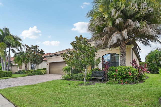 13215 Ramblewood Trl, Bradenton, FL 34211 - view of front of property with a garage, stucco siding, decorative driveway, and a front lawn