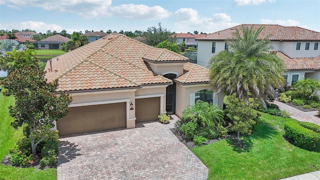13215 Ramblewood Trl, Bradenton, FL 34211 - mediterranean / spanish-style house with a residential view, stucco siding, driveway, a garage, and a tiled roof