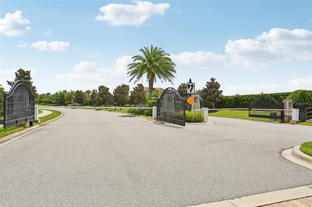 13215 Ramblewood Trl, Bradenton, FL 34211 - view of street with traffic signs, a gated entry, curbs, and a gate