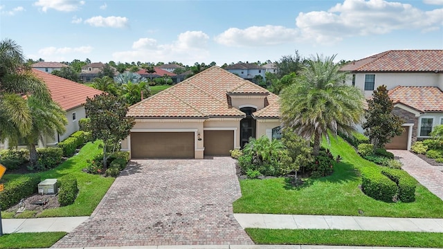 13215 Ramblewood Trl, Bradenton, FL 34211 - mediterranean / spanish-style house with a garage, a tile roof, stucco siding, a residential view, and decorative driveway