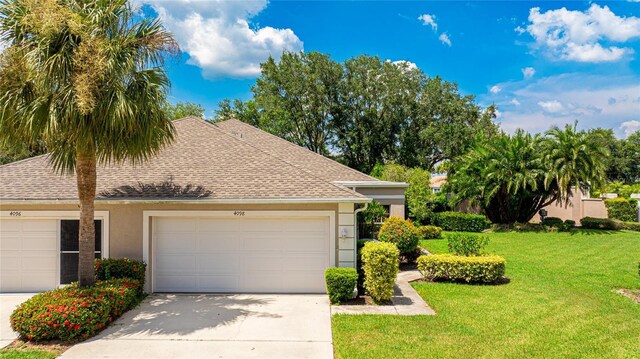 view of front of home featuring a garage and a front lawn