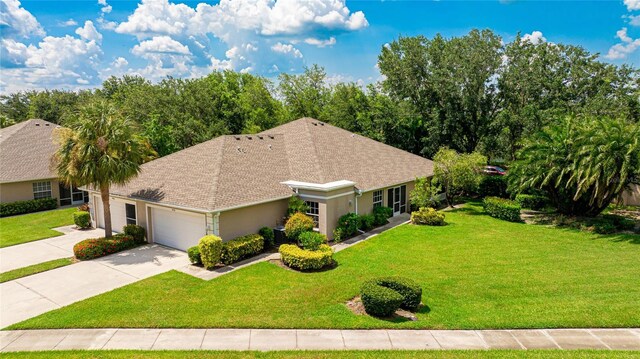 view of front of house with a garage and a front yard