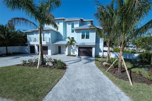 raised beach house featuring a garage and a front yard