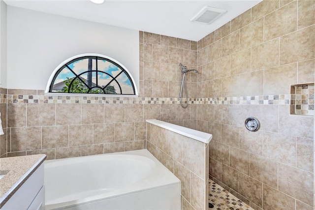 bathroom with shower with separate bathtub and vanity