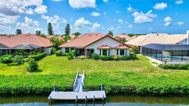 rear view of property with a water view, a yard, and glass enclosure