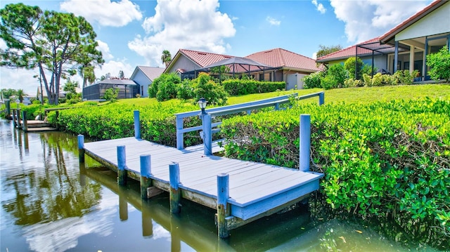 view of dock featuring a yard, a lanai, and a water view