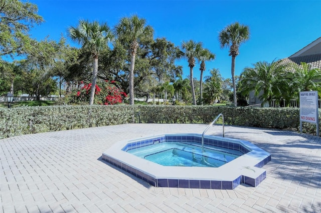 view of swimming pool with a community hot tub