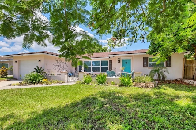 view of front of property with a garage and a front yard