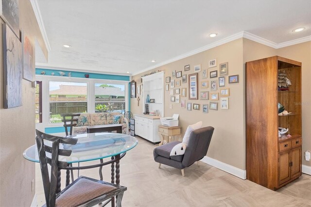 sitting room with crown molding and light tile patterned floors