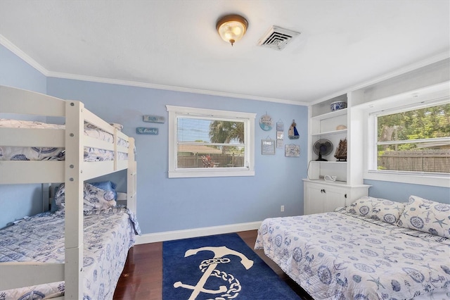 bedroom featuring multiple windows, dark wood-type flooring, and ornamental molding