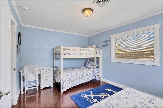 bedroom featuring hardwood / wood-style flooring and ornamental molding