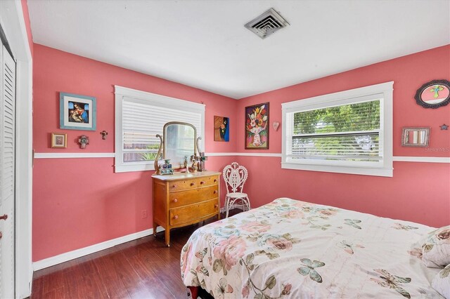 bedroom with dark hardwood / wood-style floors