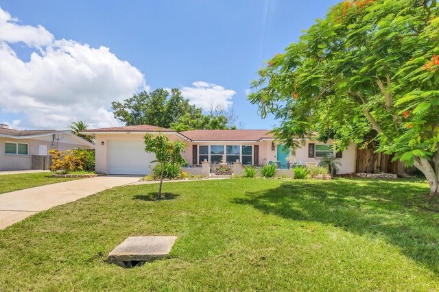 ranch-style house with a garage and a front yard