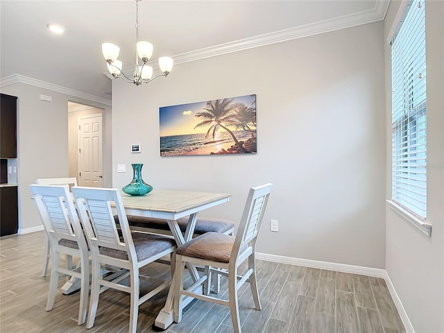 dining area with an inviting chandelier, ornamental molding, and light hardwood / wood-style floors