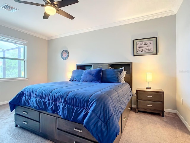 carpeted bedroom with crown molding and ceiling fan