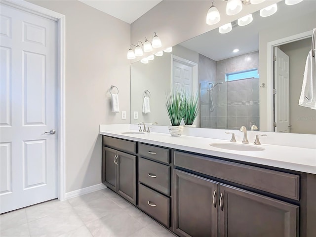 bathroom featuring tile patterned floors, vanity, and a tile shower