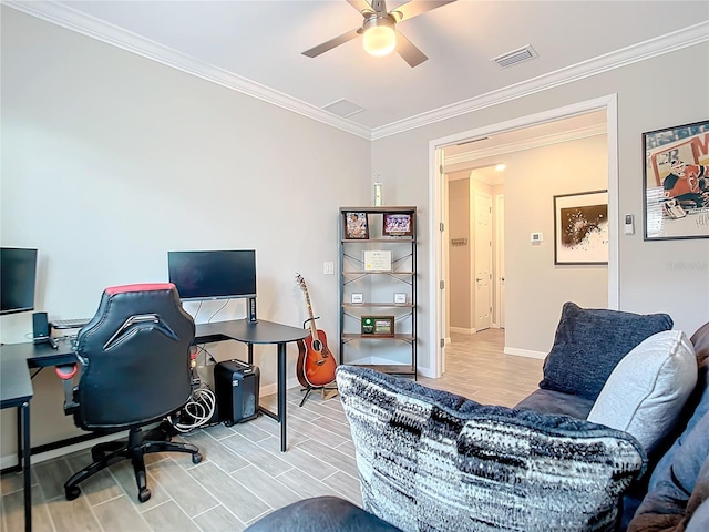 home office with crown molding, ceiling fan, and light wood-type flooring