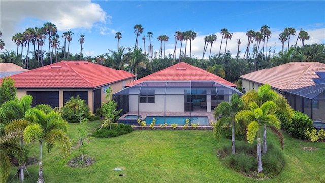 back of house with a lanai and a lawn