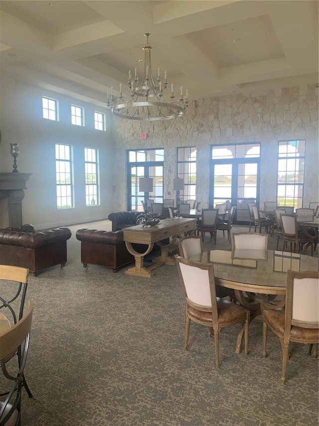 dining room with beam ceiling, carpet floors, and a towering ceiling