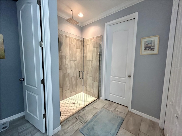 bathroom with crown molding, a shower with shower door, and tile patterned floors