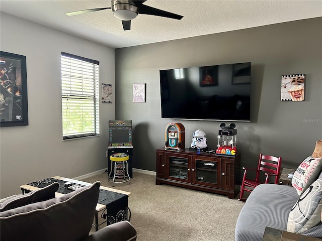 living room with a textured ceiling, ceiling fan, and carpet floors