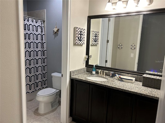 bathroom with tile patterned flooring, vanity, and toilet