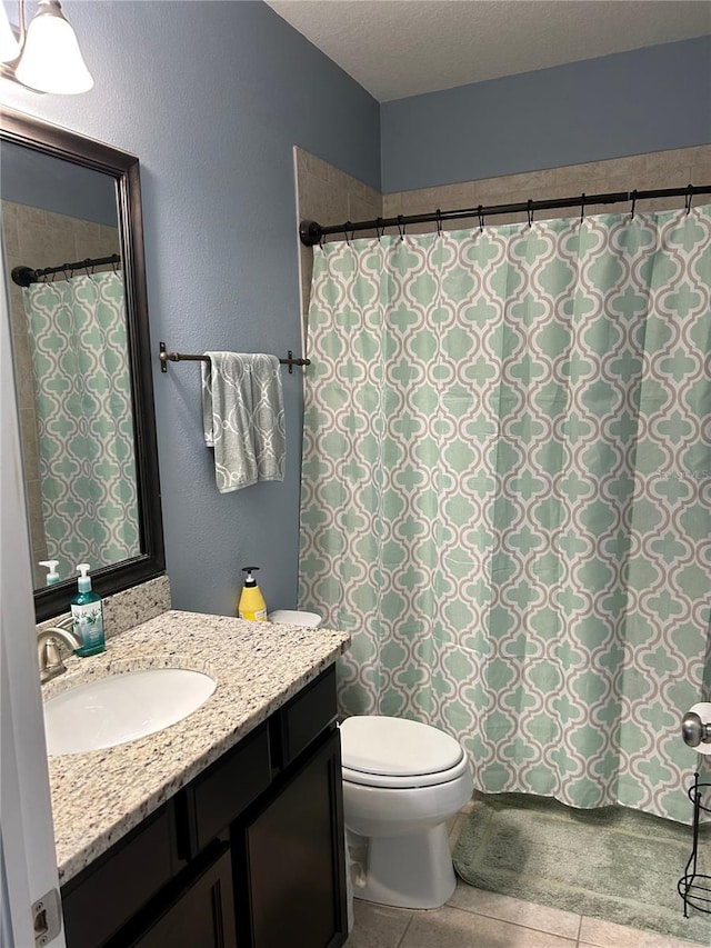 bathroom featuring vanity, toilet, and tile patterned floors