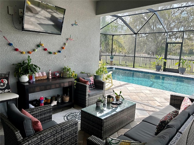 view of swimming pool featuring an outdoor living space, a lanai, and a patio area