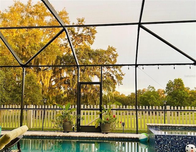 view of swimming pool featuring a lanai