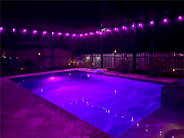 view of pool at night