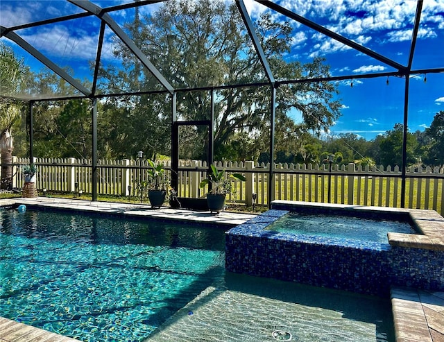 view of swimming pool with an in ground hot tub, a patio, and glass enclosure