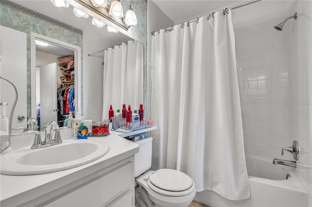 full bathroom with vanity, shower / tub combo, and toilet