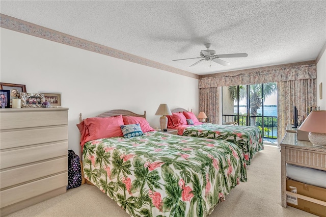 bedroom with carpet flooring, a textured ceiling, ceiling fan, and access to exterior