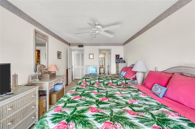 bedroom with a textured ceiling and ceiling fan