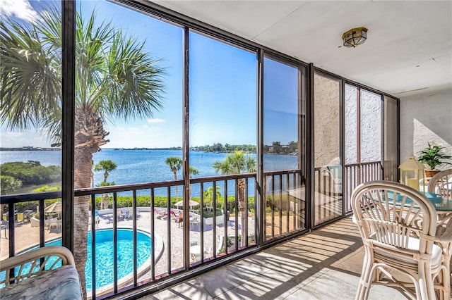 sunroom featuring a healthy amount of sunlight and a water view