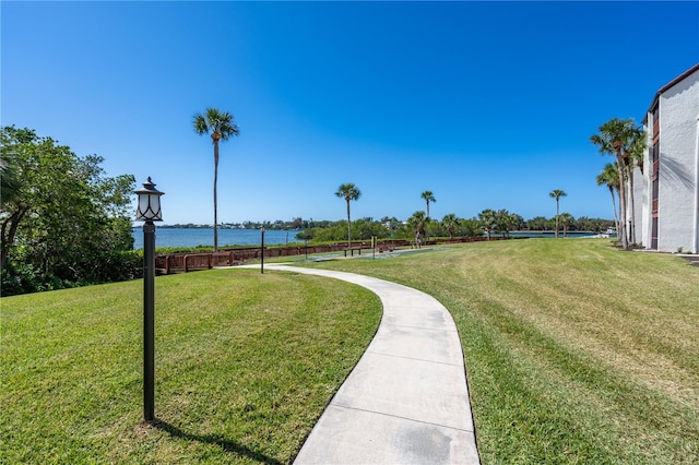 view of home's community with a yard and a water view