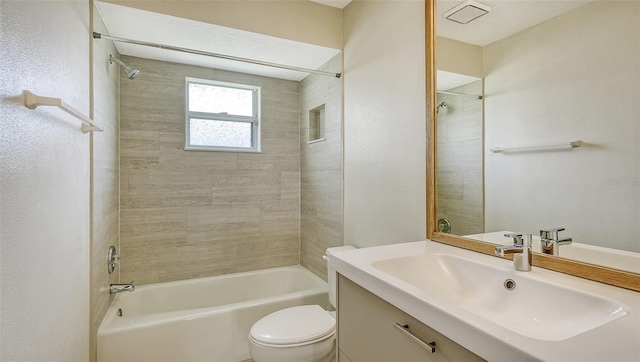 full bathroom with toilet, tiled shower / bath combo, and vanity