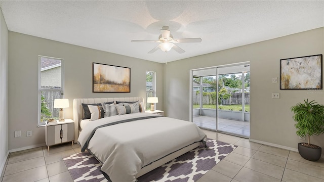 tiled bedroom with ceiling fan, a textured ceiling, and access to exterior