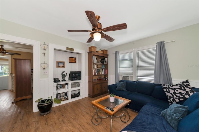 living room with wood-type flooring and ceiling fan