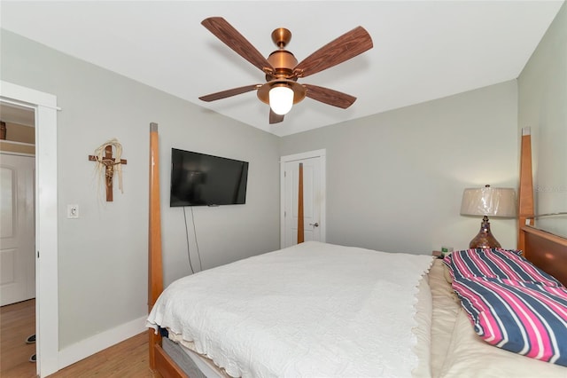 bedroom featuring ceiling fan, a closet, and light hardwood / wood-style flooring