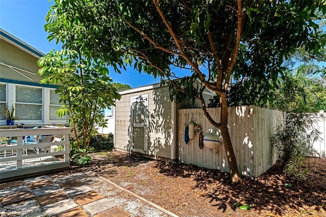 view of property exterior with a storage unit