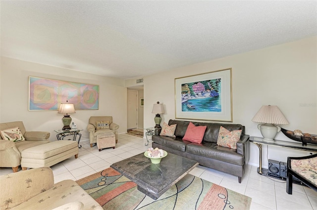 living room with visible vents, a textured ceiling, and tile patterned floors