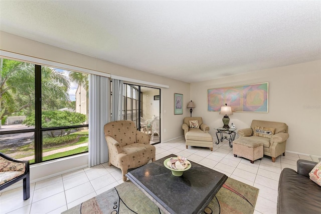 living area featuring a healthy amount of sunlight, a textured ceiling, and light tile patterned flooring