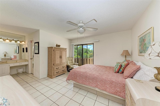 bedroom with light tile patterned floors, a textured ceiling, access to exterior, and ensuite bathroom